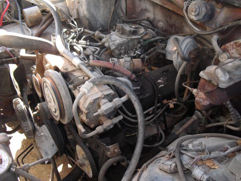 1986 Ford Bronco - Close-up view of a vehicle's engine compartment, showing various mechanical components and wiring.