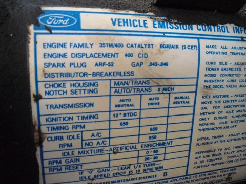 1986 Ford Bronco - Close-up of a Ford Vehicle Emission Control Information sticker detailing engine specifications and settings.
