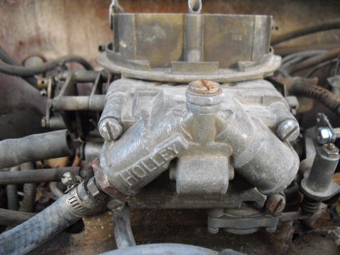 1986 Ford Bronco - This image shows a close-up view of a Holley brand carburetor, a key component of a vehicle's fuel system.