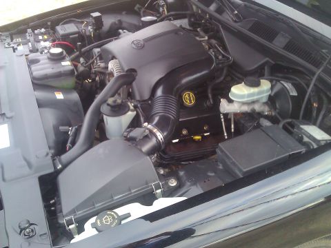 1996 Mercury Grand Marquis - Close-up view of a car's engine bay, showing the V8 engine and associated components.