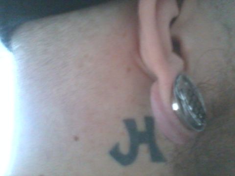 1998 Jeep Cherokee - Close-up of a neck tattoo and ear piercing.