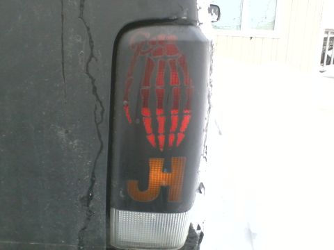 1998 Jeep Cherokee - Custom tail light features a skeleton hand graphic and JH lettering.