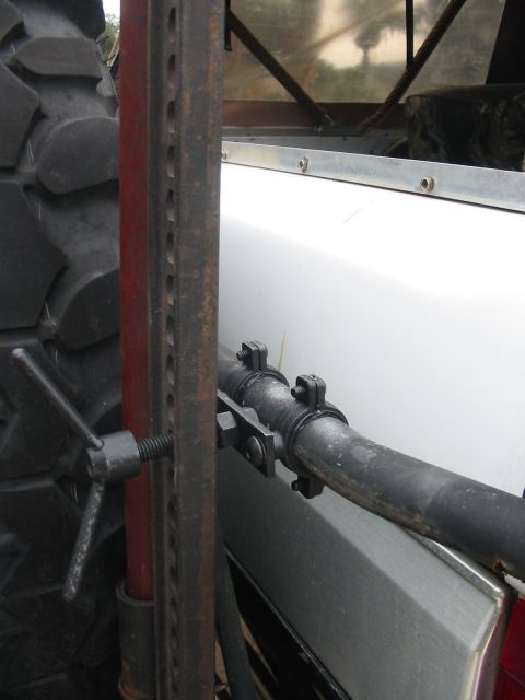 1992 Ford Bronco - A jack and tire are visible next to the side panel of a white vehicle.