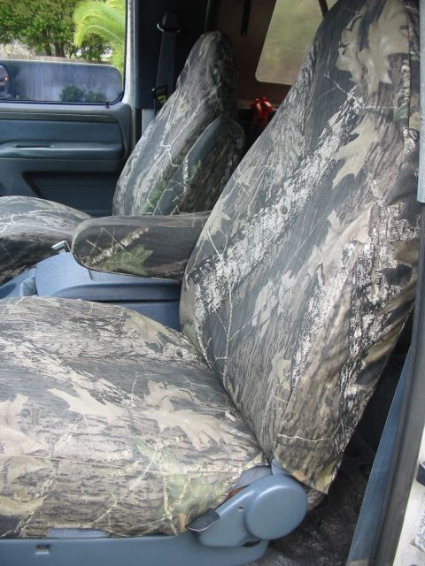 1992 Ford Bronco - Camouflage seat covers are installed on the front seats and center console of a vehicle.