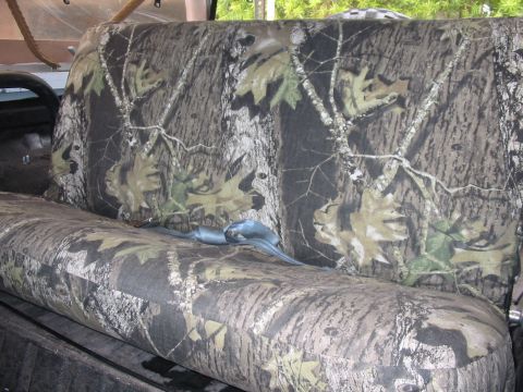 1992 Ford Bronco - Seat covers with a camouflage pattern are visible, along with a blue seatbelt.