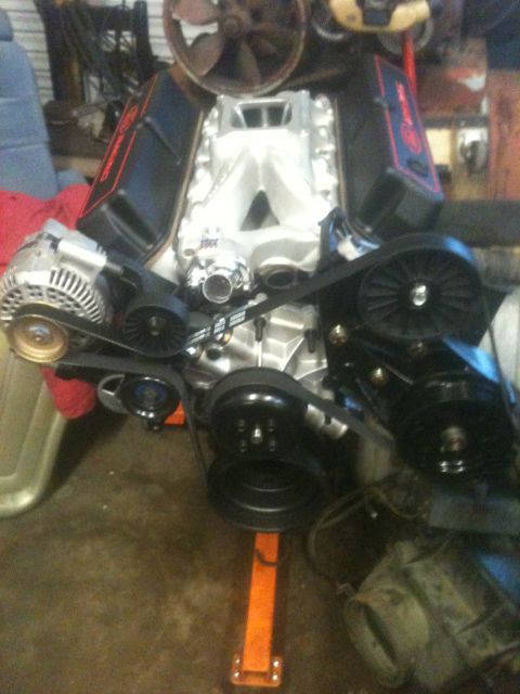 1993 Ford Bronco - Engine assembly on a stand, showing the serpentine belt system and intake manifold.