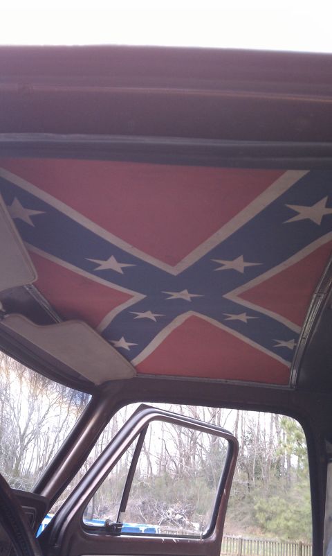 1979 Ford Bronco - The interior of a vehicle features a custom headliner displaying a confederate flag.