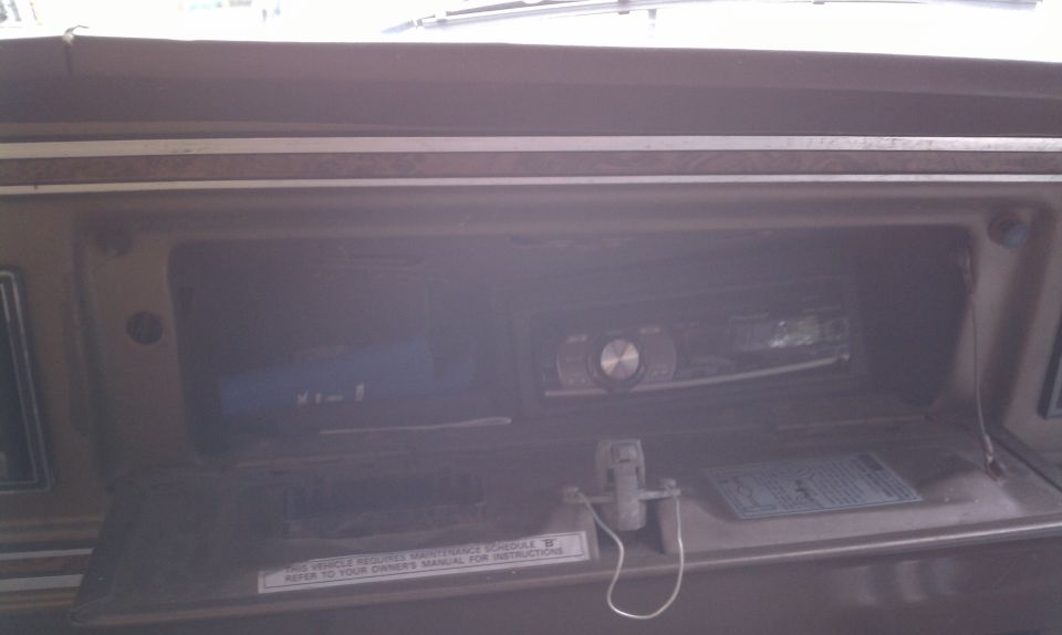 Dashboard with an aftermarket stereo installed in the center console. A small sticker is visible below the stereo