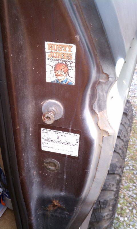 1979 Ford Bronco - A close-up of the door jamb on a 1979 Ford Bronco shows a manufacturer sticker and a humorous decal.