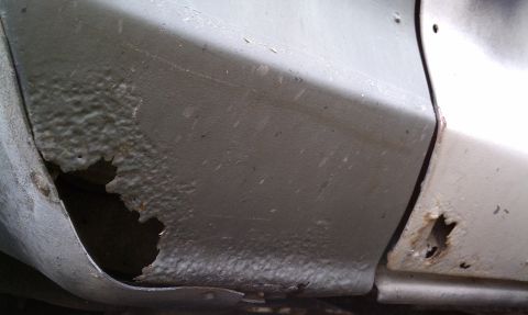 1979 Ford Bronco - Significant rust damage is visible on the lower body panel of this vehicle.