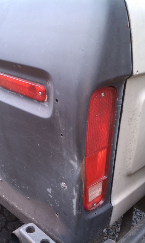 1979 Ford Bronco - Close-up of the rear quarter panel and taillight assembly, possibly from a 1978 Ford Bronco.