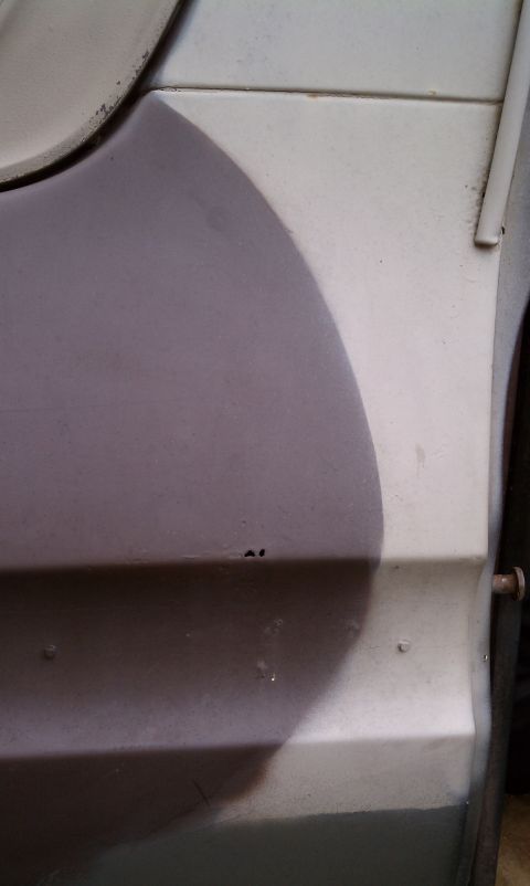1979 Ford Bronco - Vehicle body panel shows a camouflage paint job with some signs of wear and rust.