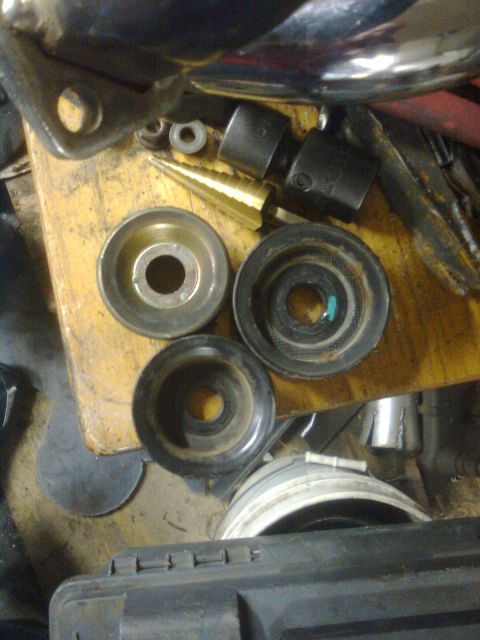 1984 Ford Bronco - Various automotive pulleys and tools are laid out on a workbench.