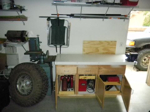 1997 Ford Ranger - A 1997 Ford Ranger truck is partially visible in the background of a garage workshop.
