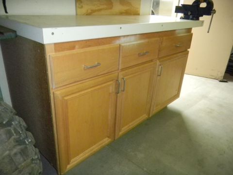 1997 Ford Ranger - Workbench with cabinets and a vise, likely in a garage or workshop setting.