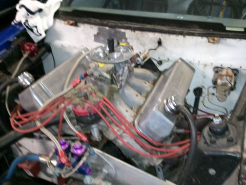 1967 Ford Mustang - Close-up view of a modified V8 engine, custom valve covers and fuel system components.