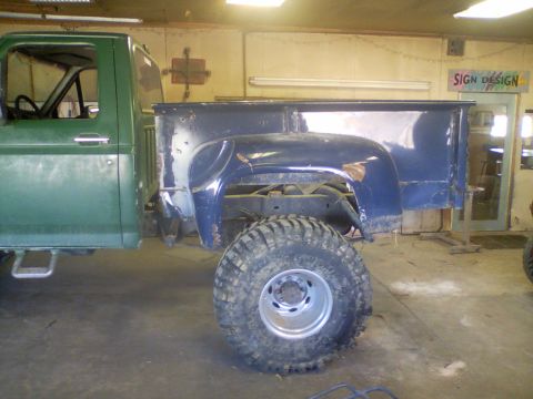 1989 Ford Bronco - Side view of a Ford truck cab and bed in a workshop, showing repair work.