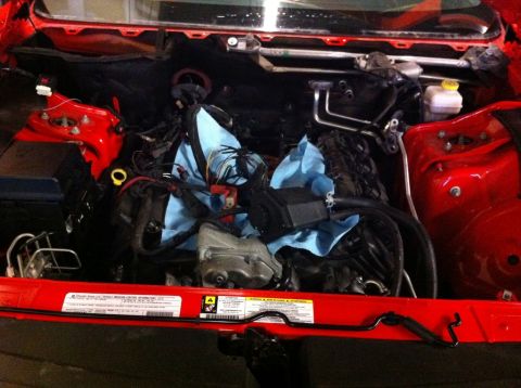 2010 Dodge Challenger - The engine bay of a 2010 Dodge Challenger is shown with the engine partially disassembled and covered.