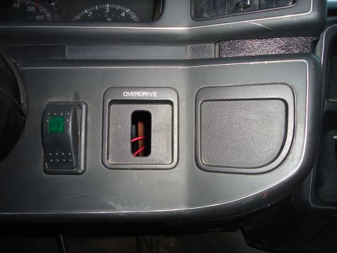 1987 Ford F-150 - Interior view of a 1987 Ford F-150 dashboard, showing the overdrive switch and part of the instrument cluster.