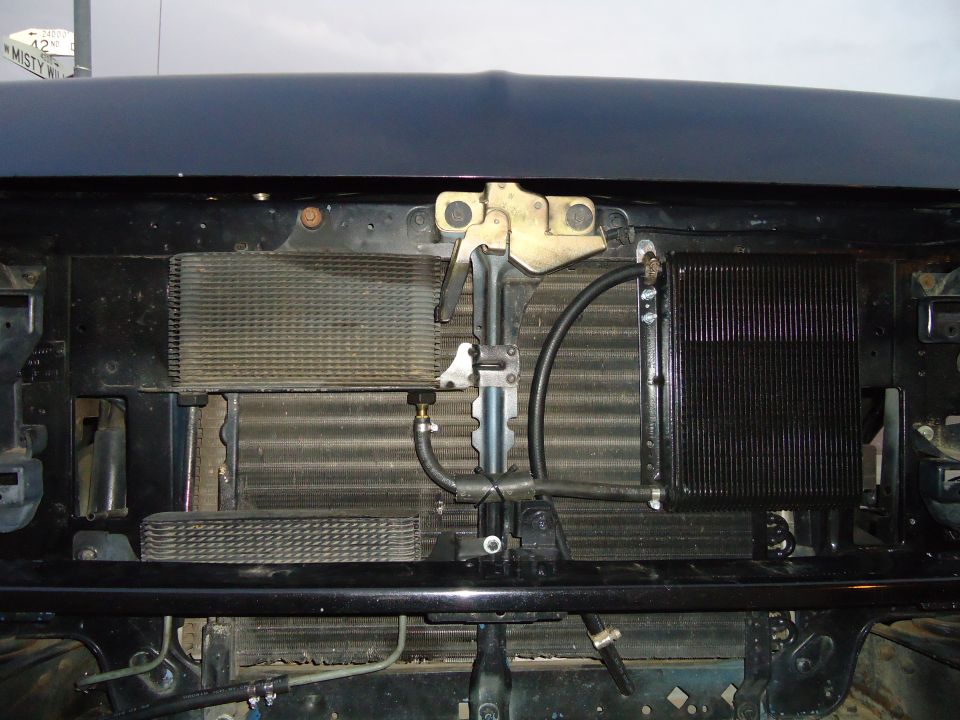 1987 Ford F-150 front radiator and transmission cooler assembly, dark blue hood above