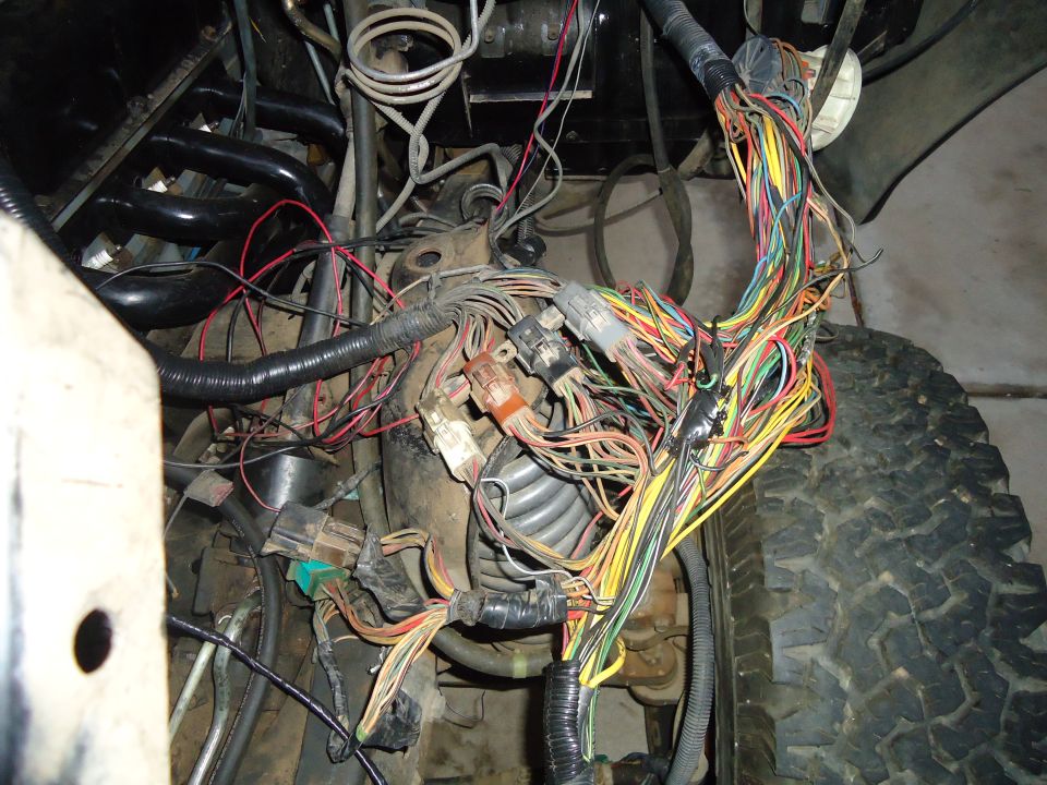 Tangled engine wiring harness with many colorful wires and connectors