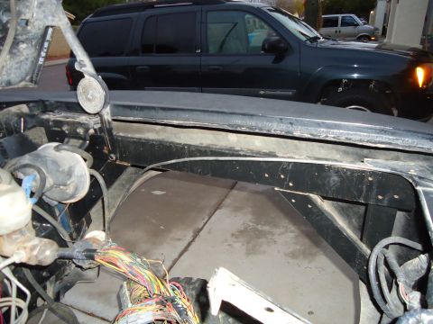 1987 Ford F-150 - The foreground shows the complex wiring of a vehicle's engine bay, with a dark SUV visible in the background.