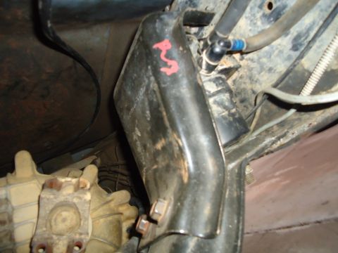 1987 Ford F-150 - Close-up view of an underbody component with red markings and fuel lines visible.