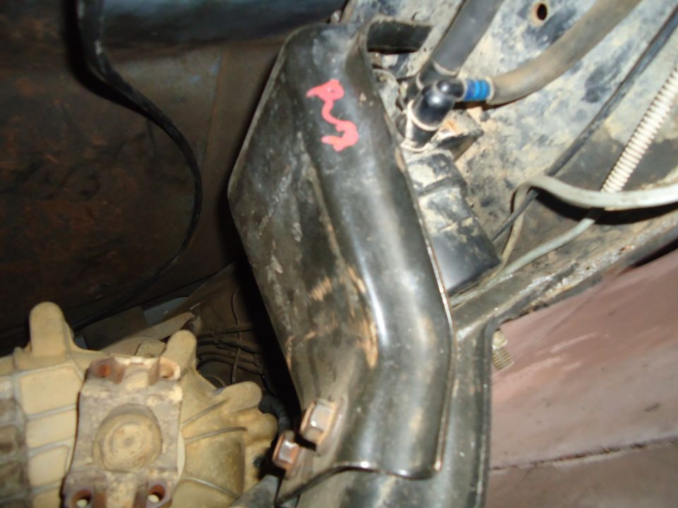 Underbody part with red markings and fuel lines