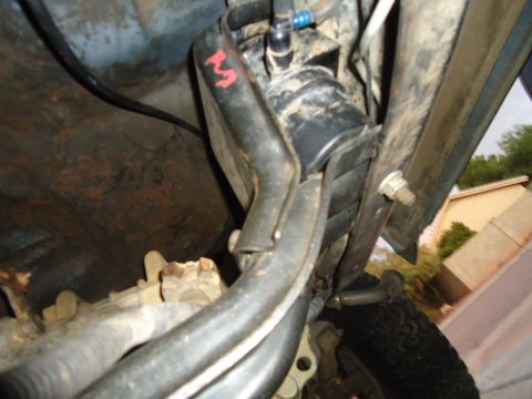 1987 Ford F-150 - Underbody view shows fuel filter and associated lines, with a red mark on one hose.