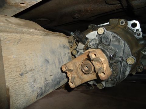 1987 Ford F-150 - Underside view of a vehicle's drivetrain components, likely a transfer case and driveshaft.