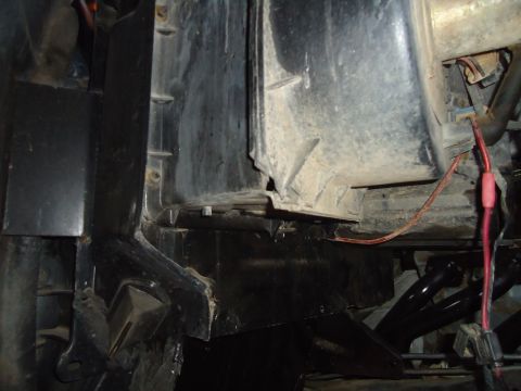 1987 Ford F-150 - Undetermined vehicle's engine bay components are visible, showing wiring and plastic housing.