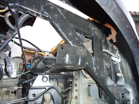 1987 Ford F-150 - Close-up view of the engine bay structure, showing the alternator and various wiring components.