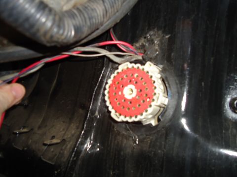 1987 Ford F-150 - A red and white electrical connector with multiple wires is visible, likely part of a vehicle's wiring harness.