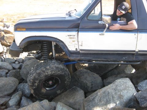 1986 Ford Bronco - This modified 1986 Ford Bronco navigates a rocky trail, its off-road capabilities.