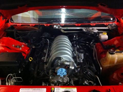 2010 Dodge Challenger - The engine bay of a car is shown, with the intake manifold as the central focus.