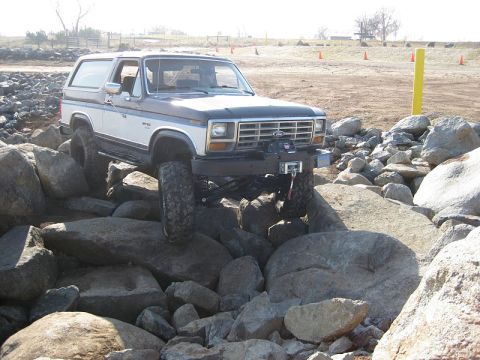 1985 Ford Bronco - Ford Bronco navigates a challenging rocky obstacle course.