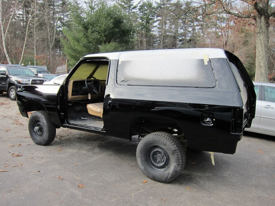 1987 Dodge 1500 SUV with doors open, being painted black and white