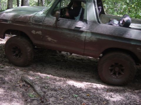 1979 Ford Bronco - This 1979 Ford Bronco, painted in camouflage, navigates a muddy trail through the woods.