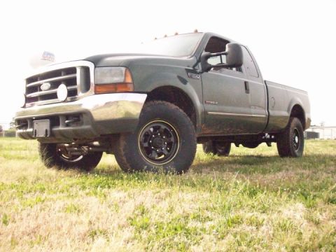 2000 Ford F-350 - This Ford F-250 Super Duty pickup truck is shown from the front quarter angle, parked on a grassy field.