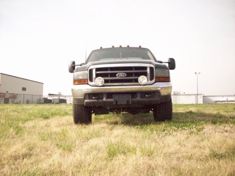 2000 Ford F-350 - Front view of a dark gray Ford F-350 truck with a chrome grille and dual headlights, parked outdoors.
