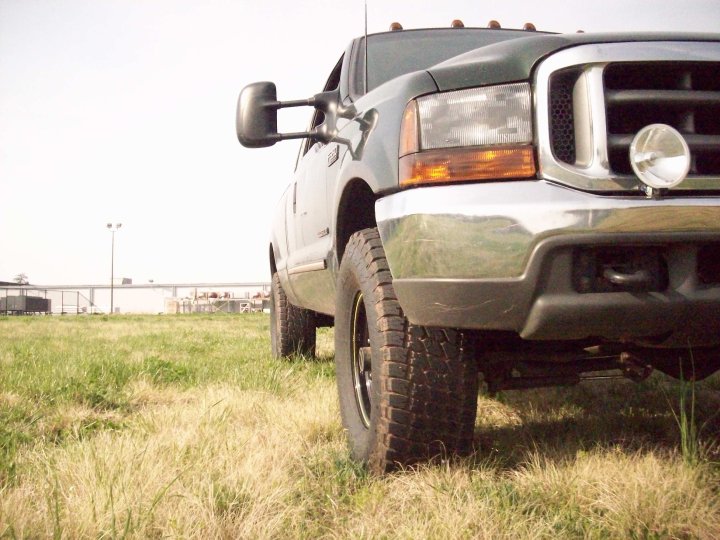 2000 Ford F-350 truck parked in a grassy field, front quarter view
