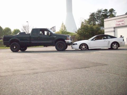 2000 Ford F-350 - A 2000 Ford F-350 Super Duty and a 2000 Ford Mustang GT are parked side-by-side.