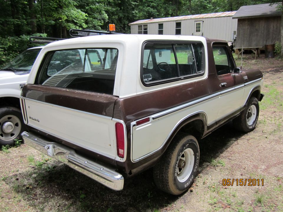 1978 Ford Bronco, two-tone brown and white, parked outdoors next to a white truck