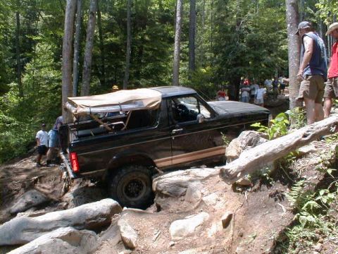 1994 Ford Bronco - This 1994 Ford Bronco tackles a challenging off-road course, demonstrating its capabilities on a steep, rocky incline.