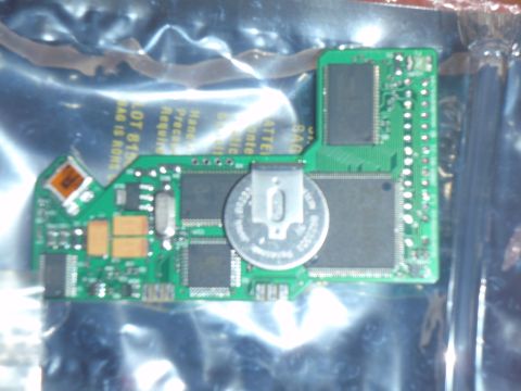 1996 Ford Bronco - This image shows a circuit board with a coin cell battery and various electronic components. Some text is visible on the board and packagin…