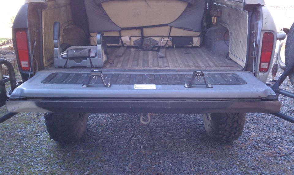 Rear view of a 1978 Ford Bronco with tailgate down, showing interior seating and cargo area