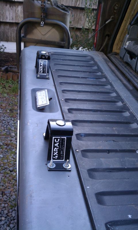 1979 Ford Bronco - Close-up of a vehicle's tailgate, showing two 4xRAC mounts and a jerry can secured above.