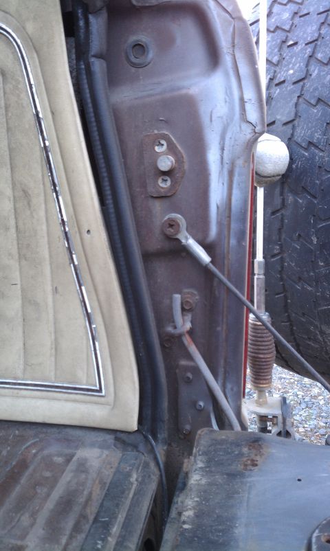 1979 Ford Bronco - Close-up view of a car's interior door jamb and a portion of a spare tire.