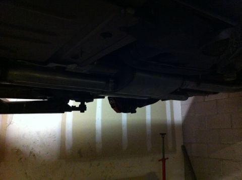 2010 Dodge Challenger - Underside view of a vehicle's exhaust system, including the muffler and pipes.