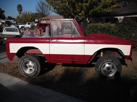 1968 Ford Bronco - This 1968 Ford Bronco is shown in a side profile, a two-tone red and white paint scheme and custom wheels.